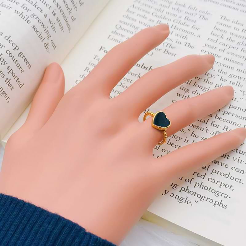22K gold black heart ring with a minimalist heart design worn on a dummy hand