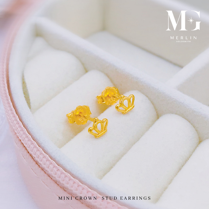 Mini gold crown stud earrings in an open outline design on a white jewellery box from Merlin Goldsmith