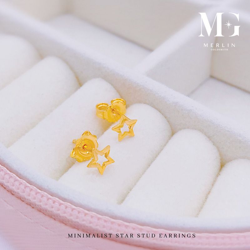 Minimalist gold star stud earrings in an open outline design on a pink jewellery box from Merlin Goldsmith