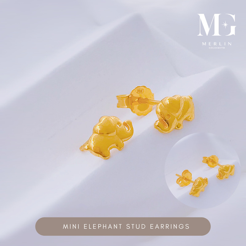 Mini gold elephant stud earrings with a glossy finish on a white fabric background from Merlin Goldsmith